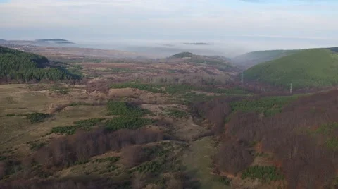 Flying over the hills from the top view of clouds Aerial slide shot Stock Footage 58254041