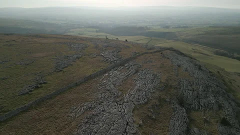 Flying over hillside and limestone pavement revealing green patchwork Stock-Footage 233569752