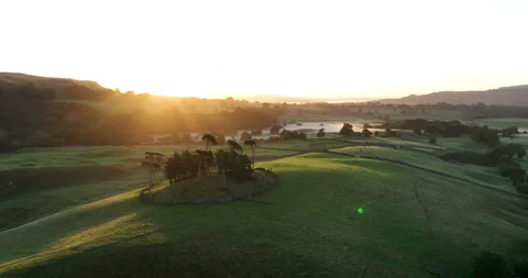 Flying over a hilly valley in north Yorkshire at sunrise Stock Footage 219937531
