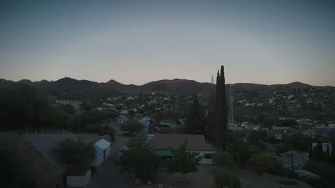 Flying over homes toward a cell phone tower in a small town Stock Footage 201763176