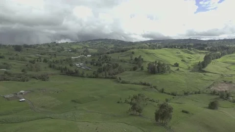 Flying over the horizon, clouds, hills, grass and trees Stock Footage 219832844