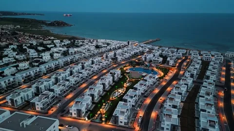 Flying over hotels by the sea. Evening sea city. Night city. Night street. Stock Footage 276372184