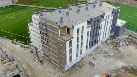 Flying over a house under construction. The house surrounding the sports complex Stock Footage 125823967