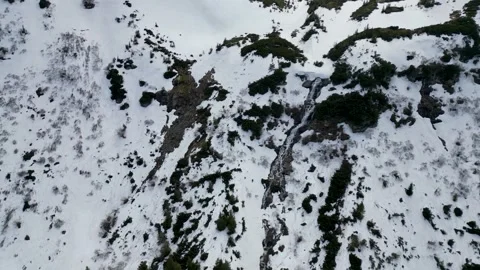 Flying over the Hoverlyansky waterfall in the mountains, melting snow Stock Footage 242811604