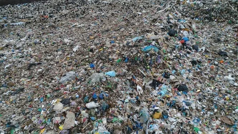 Flying over a huge garbage dump of unsorted trash. Flocks of crows over dump. Stock Footage 119474503