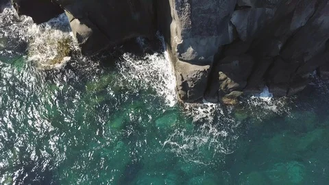 Flying over the huge rocks cliff in ocean. Stock Footage 108037868