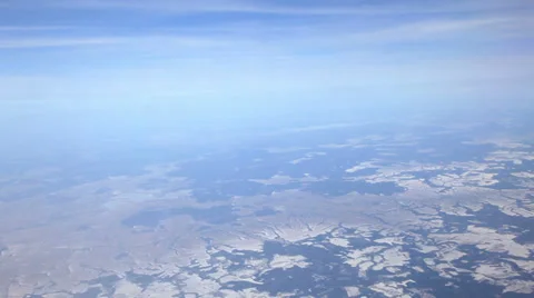 Flying over ice fields, snowy landscape. View from plane side window Stock Footage 36428939