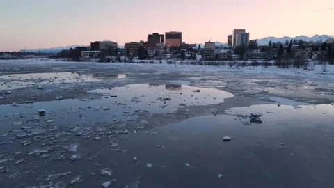Flying over icy waters towards building in Anchorage alaska Stock-Footage 168859622