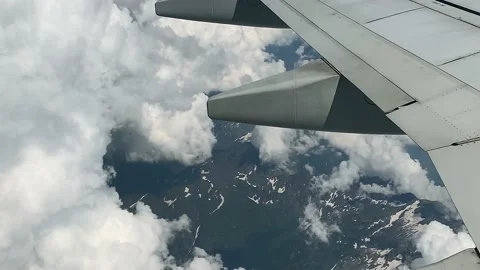 Flying over islands of beautiful clouds over a mountain landscape - handheld Video stock 227567657