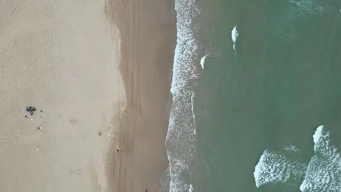Flying over the junction of sand and sea on the beach Video stock 316288229