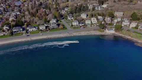 Flying over Kitty Islet beach. Fast boat pulling skier along the waterfront. Stock Footage 270126150