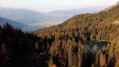 Flying over the "Lac Vert" (green lake) in Plateau d'Assy, french Alps. Video stock 140782613