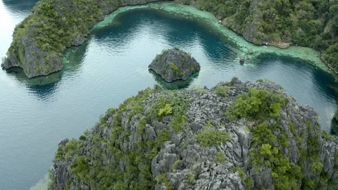 Flying over a lagoon with abstract rock formations Stock Footage 102833737