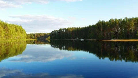 Flying over the lake on a drone. Reflection in the lake. Forests Stock Footage 116998855