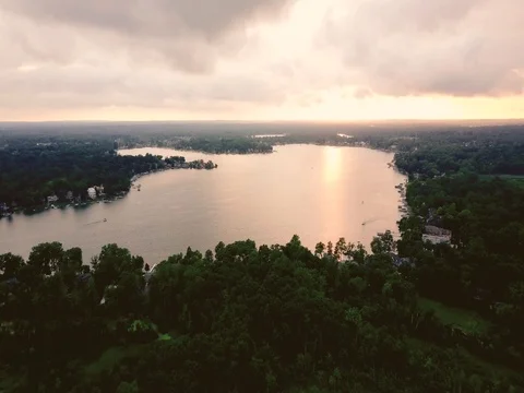 Flying over a lake at sunset Stock Footage 78141056