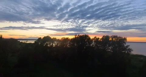 Flying over a lake on a sunset. Stock Footage 91404437