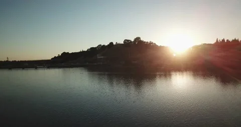 Flying over lake at sunset 스톡 동영상 134910368