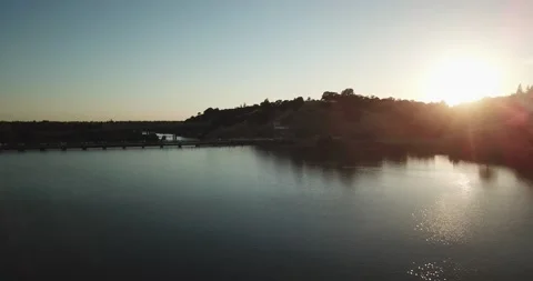 Flying over lake at sunset Stockbeeldmateriaal 134910647