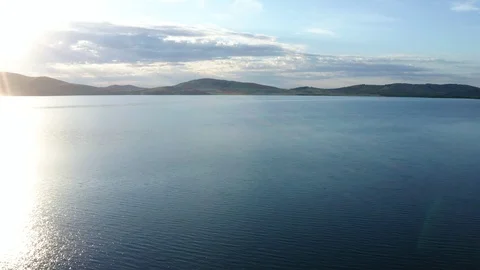 Flying over the lake surrounded by mountains. Stock Footage 119071182