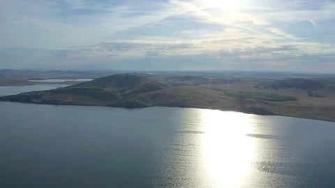 Flying over the lake surrounded by mountains. Stock Footage 119071659