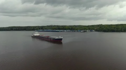 Flying over a large cargo ship with open holds sailing down Stock Footage 131626232