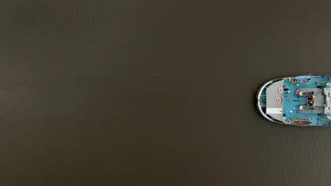 Flying over a large cargo ship with open holds sailing down a calm river Video stock 131627666