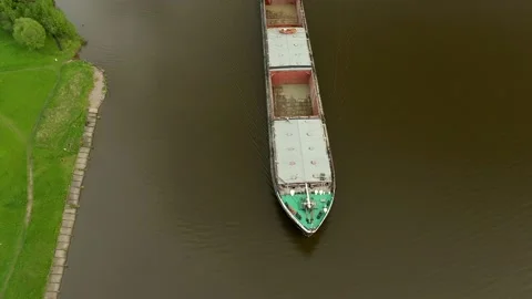 Flying over a large cargo ship with open holds sailing down Stock Footage 131627924