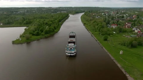 Flying over a large cargo ship with open holds sailing down Stock Footage 131628325