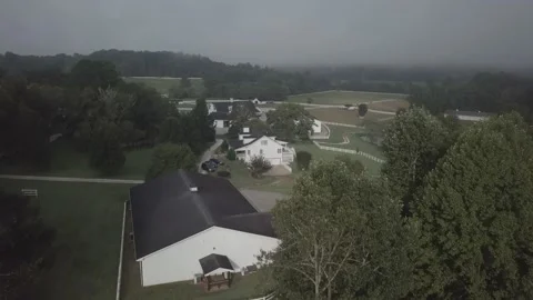 Flying over a large cloudy farmland Stock Footage 162409992