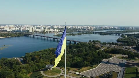 Flying over the large flagpole of the yellow-blue flag of Ukraine. Kyiv, Ukraine Stock Footage 141022113