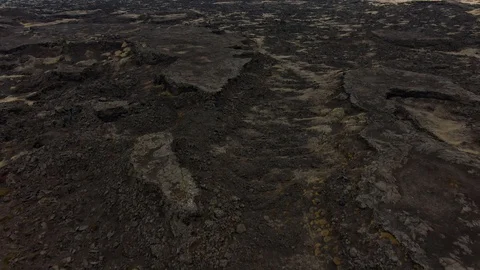 Flying Over a Lava Field Tilting Upwards Stock Footage 130137295