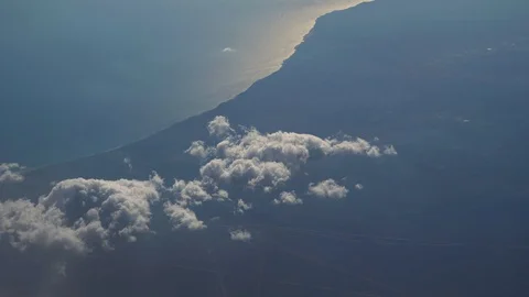 Flying over the layer of clouds and looking on landscape through the clouds. Video stock 112145790