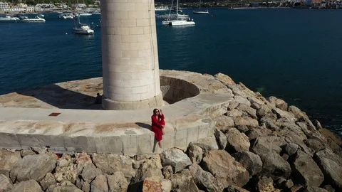 Flying over the lighthouse in the bay of andratx majorca spain Stock Footage 121694424