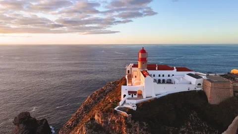 Flying over the lighthouse on Cabo de Sao Vicente at sunset, Portugal Stock Footage 267048235
