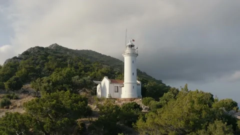 Flying over a lighthouse on the hill. Mountains on the background, Turkey 4K. Video stock 133074917