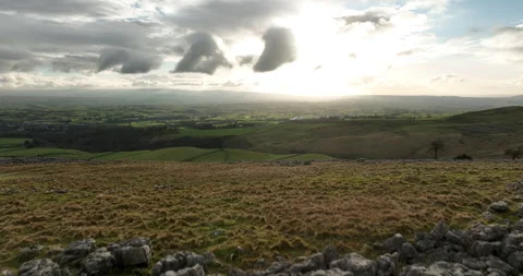 Flying over limestone pavement and green hills Stock Footage 276002348
