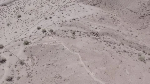 Flying over the line between desert landscape and busy city streets Stock Footage 245509672