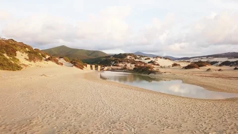 Flying over a little lake in the beach Stock Footage 80613478