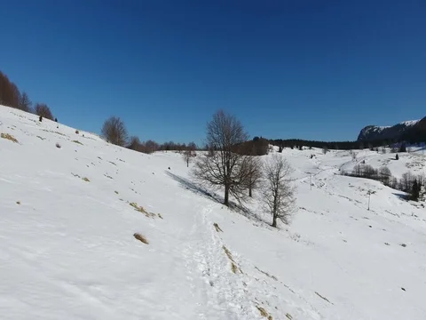 Flying over little path in the snowy mountains Stock Footage 72715941
