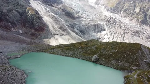 Flying over Locce lake at the base of Monte Rosa mountain Stock Footage 139921409