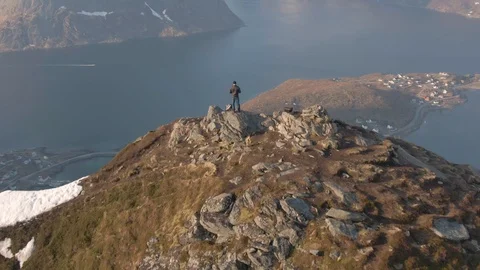 Flying Over a Lone Hiker at the Summit of Reinebringen In Lofoten Stock Footage 116359407