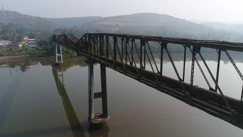 Flying over a long aqueduct over a muddy river. Aerial view. 스톡 동영상 85454151