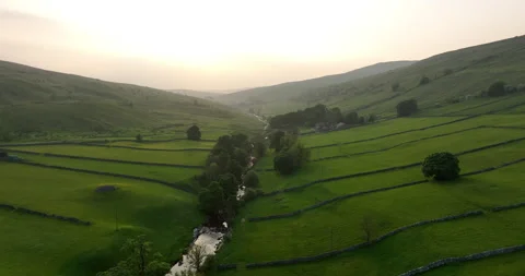 Flying over lush valley at sunset Video stock 282904485