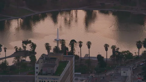 Flying over MacArthur Park downtown Los Angeles at sunset. Wide shot filmed with Stock Footage 199459702
