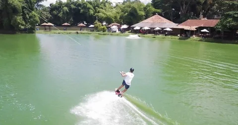 Flying over Man Wakerboarding Cable. Wake Park. Green Water Vídeo Stock 88976581