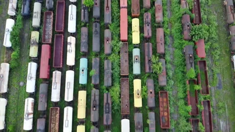 Flying over many colored train cars near Ploiesti City , Romania Stock-Footage 132959794