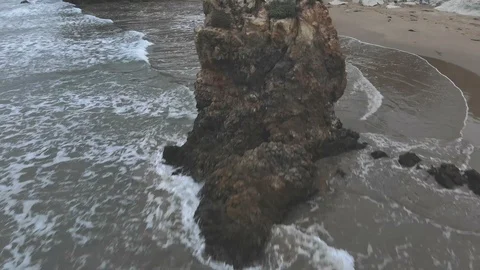 Flying Over Massive Rock Formation on Beach Stock-Footage 107578097