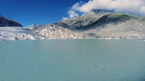 Flying over melting ice floe. glacier lake panorama. mountain alps Stock Footage 64536839