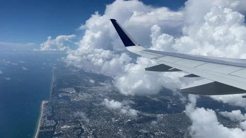 Flying over Miami. View of east coast from plane's window. Beautiful white Stock Footage 137968360