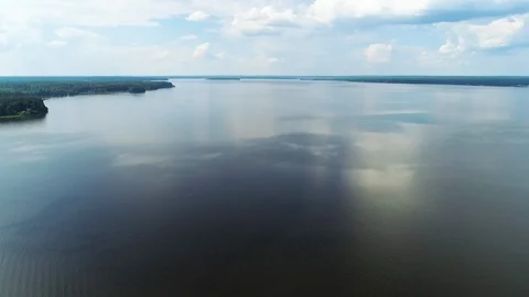 Flying over the mirror, blue smooth surface of the lake. 스톡 동영상 104371504